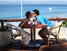 Couple kissing seaside restaurant