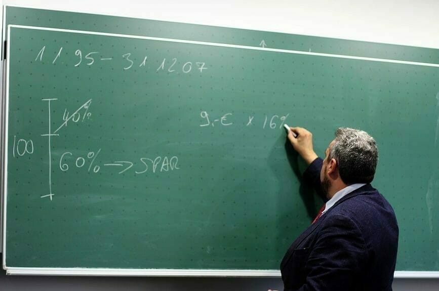 Math teacher writing on a board